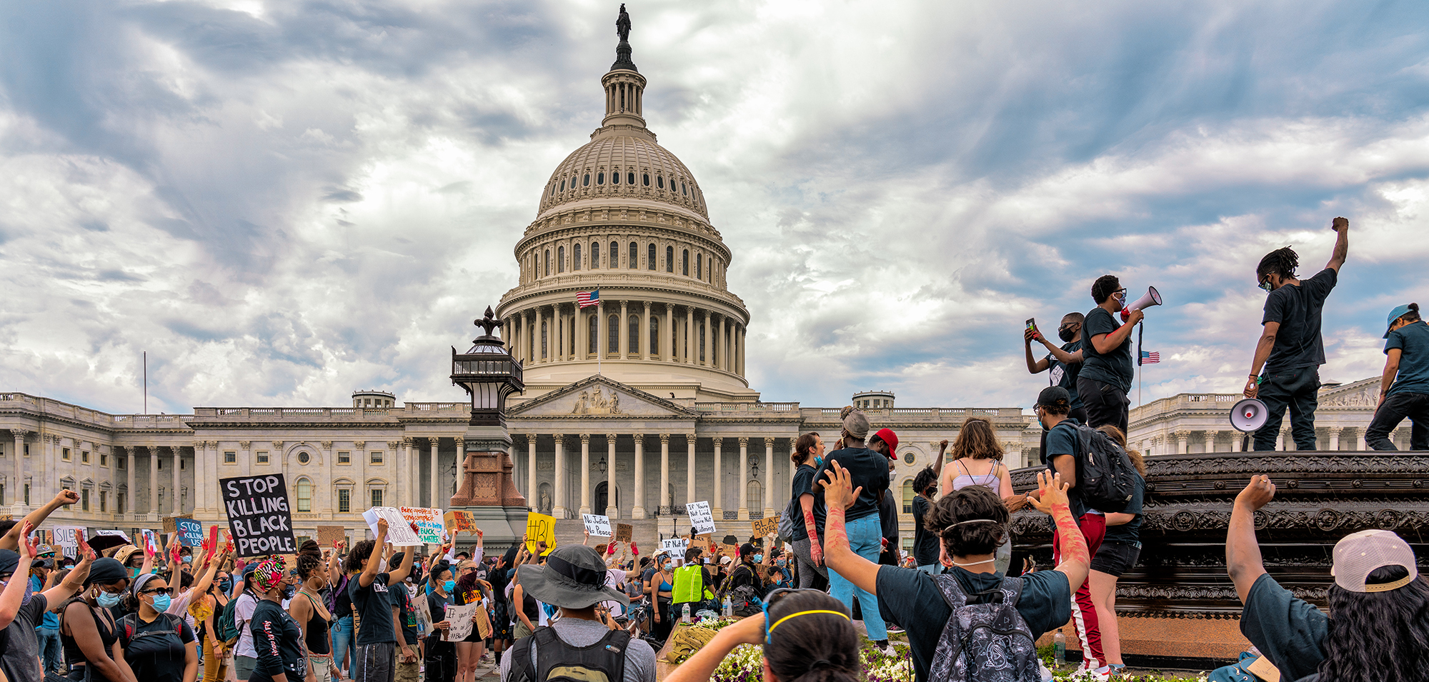 A crowd protesting in front of the capitol building.