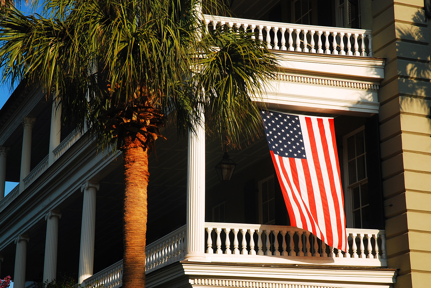 an american flag hanging from the side of a building.