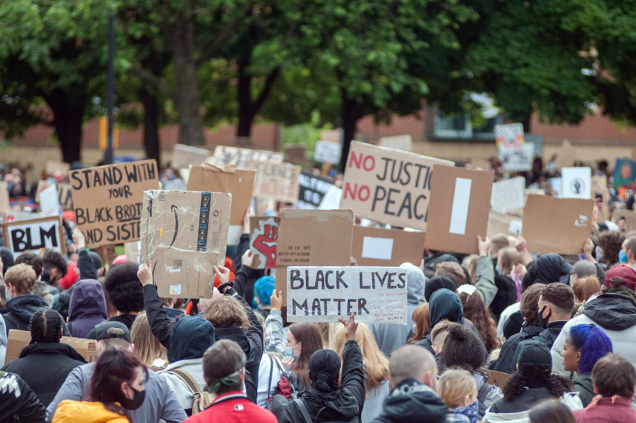 a large group of people holding signs in a protest.