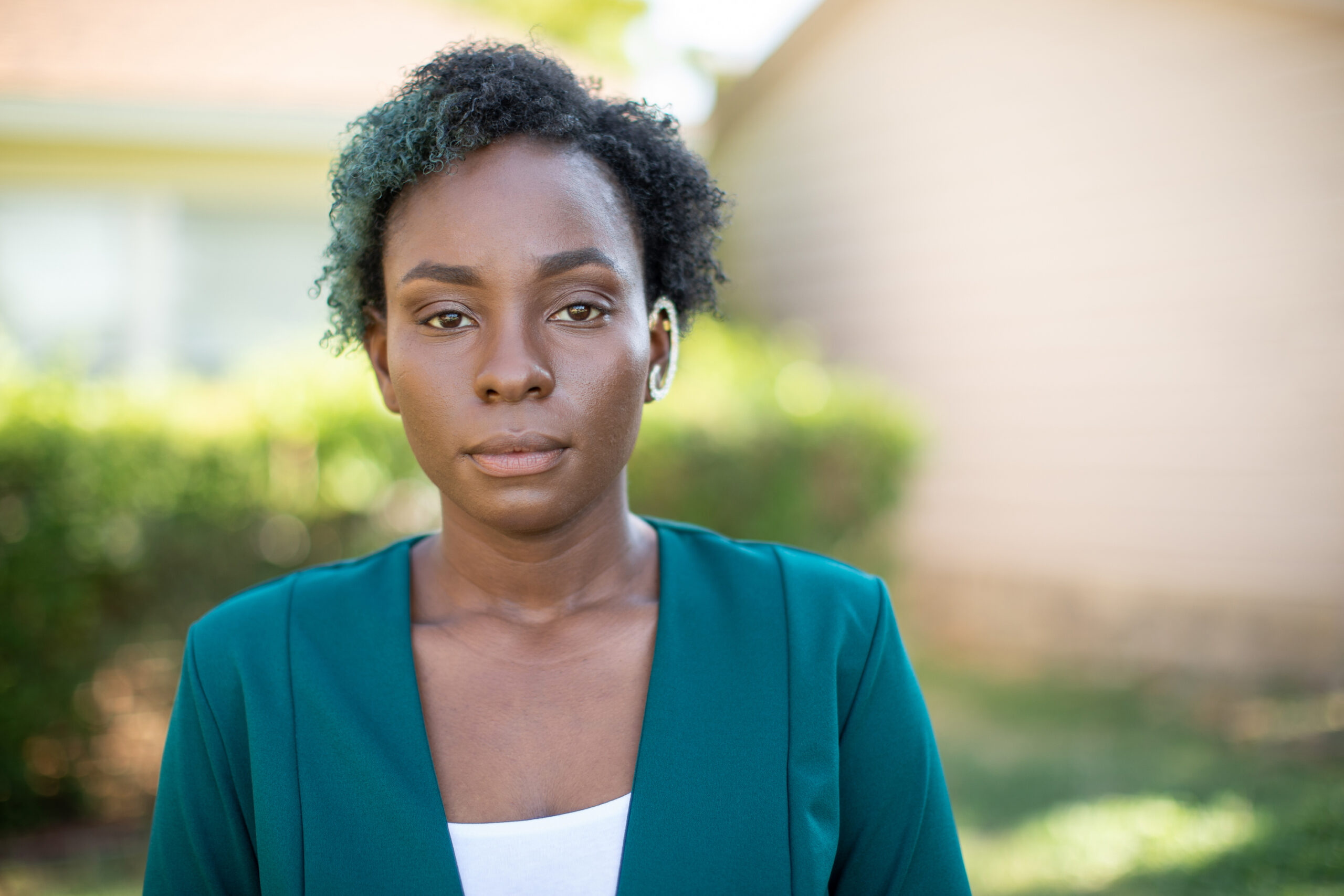 a woman standing in front of a house.